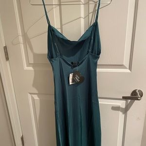 Green silk slip dress with cowl neck line and a slit
